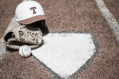home plate with baseball glove, ball, and hat