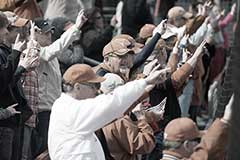 fans doing hook 'em hand sign